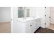 Bright bathroom featuring a double sink vanity and walk-in shower at 2721 Creek View Nw Ter, Atlanta, GA 30318