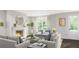 Cozy living room with a fireplace, neutral furniture, and bright natural light at 2721 Creek View Nw Ter, Atlanta, GA 30318