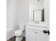 Bathroom with a toilet and vanity with white cabinets and countertops at 2725 Creek View Nw Ter, Atlanta, GA 30318