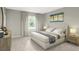 Cozy bedroom featuring neutral tones, plush carpeting, a comfortable bed, and a serene window view at 2725 Creek View Nw Ter, Atlanta, GA 30318