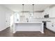 Modern kitchen featuring white cabinets, a central island, stainless steel appliances, and stylish pendant lighting at 2725 Creek View Nw Ter, Atlanta, GA 30318