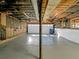 Unfinished basement featuring a painted concrete floor and exposed ceiling beams at 3248 Holly Mill Run, Marietta, GA 30062