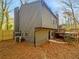 View of the side of a gray house featuring a deck and a small fenced yard at 3248 Holly Mill Run, Marietta, GA 30062