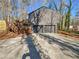 Attached two-car garage with a wooden staircase and landscaping in the background at 3248 Holly Mill Run, Marietta, GA 30062
