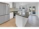 Bright, modern kitchen features stainless steel appliances, center island, and access to outdoor deck at 3248 Holly Mill Run, Marietta, GA 30062