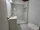 Modern bathroom features a sleek vanity, toilet, and a stylish glass-enclosed shower with marbled tile at 336 Sir Richard Ct, Jonesboro, GA 30236