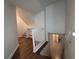 Spacious hallway with hardwood floors, fresh paint, and an open staircase, creating a welcoming atmosphere at 336 Sir Richard Ct, Jonesboro, GA 30236