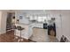 Bright kitchen with white cabinets, modern appliances, breakfast bar and hardwood floors at 336 Sir Richard Ct, Jonesboro, GA 30236