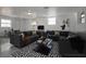 Contemporary living room with stylish furniture, striking black and white rug, and ample natural light at 336 Sir Richard Ct, Jonesboro, GA 30236