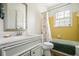 Bathroom features a white vanity with marble countertop, a toilet, and a shower/tub combo with a colorful curtain at 545 Bellemeade Sw Dr, Marietta, GA 30008