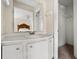 Practical bathroom features a single sink vanity, white cabinets, bright lighting, and a hallway closet at 545 Bellemeade Sw Dr, Marietta, GA 30008