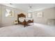 Spacious bedroom features plush carpeting, bright natural light through multiple windows, and an adjacent ensuite bathroom at 545 Bellemeade Sw Dr, Marietta, GA 30008