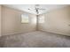 Bedroom features neutral walls, carpet flooring, two windows providing natural light, and a ceiling fan at 545 Bellemeade Sw Dr, Marietta, GA 30008