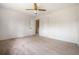 Bright bedroom featuring neutral walls, carpet flooring, a ceiling fan, and a doorway to the hallway at 545 Bellemeade Sw Dr, Marietta, GA 30008