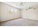 Spacious bedroom featuring neutral walls, carpet flooring, ceiling fan, and natural light from a double window at 545 Bellemeade Sw Dr, Marietta, GA 30008