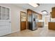 Spacious kitchen boasts wood cabinets, stainless steel appliances, tile countertops and flooring, and easy access to outdoors at 545 Bellemeade Sw Dr, Marietta, GA 30008