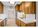 Well-lit kitchen featuring wood cabinets, stainless steel appliances, and tile countertops offering cooking and prep space at 545 Bellemeade Sw Dr, Marietta, GA 30008