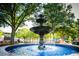 Picturesque multi-tiered water fountain surrounded by lush greenery in a town square at 545 Bellemeade Sw Dr, Marietta, GA 30008