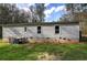 Backyard exterior with an AC unit, siding, and a grassy lawn at 643 Tumlin Lake Rd, Temple, GA 30179