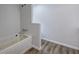 Bathroom featuring a soaking tub and vinyl flooring at 643 Tumlin Lake Rd, Temple, GA 30179
