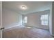 Bright bedroom features two windows, carpet, and neutral paint at 643 Tumlin Lake Rd, Temple, GA 30179
