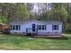 Charming home with blue shutters, a covered porch, and a well-maintained lawn at 643 Tumlin Lake Rd, Temple, GA 30179