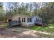 Exterior featuring a wooden deck, shed, and natural surrounding at 643 Tumlin Lake Rd, Temple, GA 30179