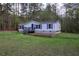 Charming single-story home with a blue front door and a well-maintained lawn at 643 Tumlin Lake Rd, Temple, GA 30179