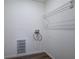 Small laundry room with storage shelving and vinyl wood flooring at 643 Tumlin Lake Rd, Temple, GA 30179