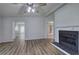 Spacious living room with a fireplace, wood-style floors, and lots of natural light at 643 Tumlin Lake Rd, Temple, GA 30179