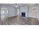 Bright living room with hardwood floors and a cozy fireplace feature at 643 Tumlin Lake Rd, Temple, GA 30179