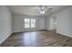 Open living room with wood flooring, lots of natural light, and a ceiling fan at 643 Tumlin Lake Rd, Temple, GA 30179