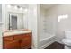 Bathroom featuring a vanity with wood cabinets and a shower-tub combo with white tile at 109 Odyssey, Conyers, GA 30012