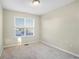 This bedroom features neutral walls, carpet flooring, and a window offering natural light at 109 Odyssey, Conyers, GA 30012