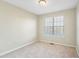 This bedroom features neutral walls, carpet flooring, and a window offering natural light at 109 Odyssey, Conyers, GA 30012