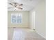 Spacious bedroom featuring a ceiling fan, a large window, and neutral carpet at 109 Odyssey, Conyers, GA 30012