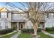 Charming townhome featuring a welcoming porch, landscaped front yard and sidewalk at 109 Odyssey, Conyers, GA 30012