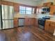 Well-equipped kitchen with stainless steel appliances, wooden cabinets and modern countertop at 109 Odyssey, Conyers, GA 30012