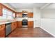Functional kitchen with stainless steel appliances, wood cabinets, hardwood floors, and natural light at 109 Odyssey, Conyers, GA 30012