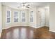 Bright living room featuring hardwood floors, large windows, and a ceiling fan for comfortable living at 109 Odyssey, Conyers, GA 30012