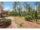 Large backyard featuring a well-maintained lawn, mature trees, and a brick patio with upper deck at 4151 Valley Wood Nw Dr, Marietta, GA 30064