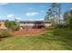 Expansive backyard with a blend of lush lawn, mature trees, a deck, and established landscaping at 4151 Valley Wood Nw Dr, Marietta, GA 30064