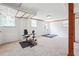 The basement features a stationary bicycle on the carpeted floors at 4151 Valley Wood Nw Dr, Marietta, GA 30064