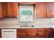 A kitchen with wooden cabinets, granite countertops, stainless steel sink, and a window with a view at 4151 Valley Wood Nw Dr, Marietta, GA 30064