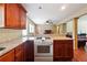 Well-equipped kitchen featuring cherry wood cabinetry, granite countertops, and hardwood floors open to the living area at 4151 Valley Wood Nw Dr, Marietta, GA 30064