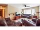 A spacious living room featuring leather couches, a ceiling fan, and a large window at 4151 Valley Wood Nw Dr, Marietta, GA 30064