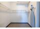 Functional walk-in closet with shelving, rod for hanging clothes, and an ironing board at 5300 Peachtree Rd # 3206, Atlanta, GA 30341