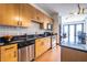 Well-appointed kitchen with stainless steel appliances, wooden cabinets, granite countertop, and hardwood floors at 5300 Peachtree Rd # 3206, Atlanta, GA 30341