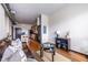 Open-concept living area with hardwood floors, modern lighting, a leather sofa, and a kitchen view at 5300 Peachtree Rd # 3206, Atlanta, GA 30341