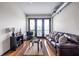Inviting living room with stylish furnishings, balcony access, and hardwood flooring at 5300 Peachtree Rd # 3206, Atlanta, GA 30341